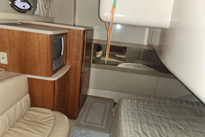Slide: The Image of Interior of a 2004 Meridian 411 Sedan yacht with TV, bed, and seating area. - 23