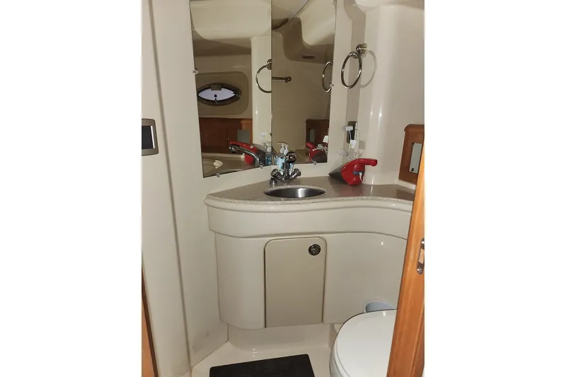 Slide: The Image of Bathroom interior of 2004 Meridian 411 Sedan yacht, featuring sink and mirror. - 26