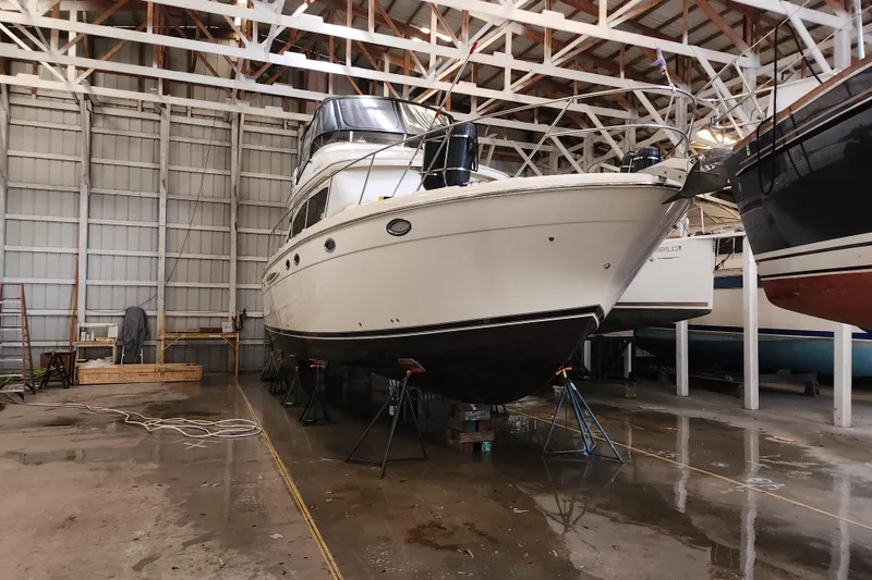 Slide: The Image of 2004 Meridian 411 Sedan yacht in dry dock, indoor storage facility. - 3