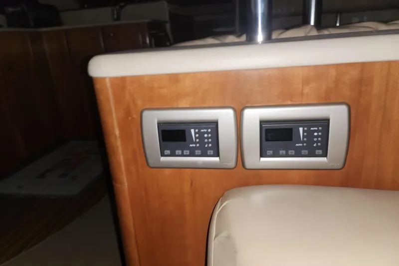 Slide: The Image of Control panels on a 2004 Meridian 411 Sedan yacht interior, featuring wood finish and modern design. - 31