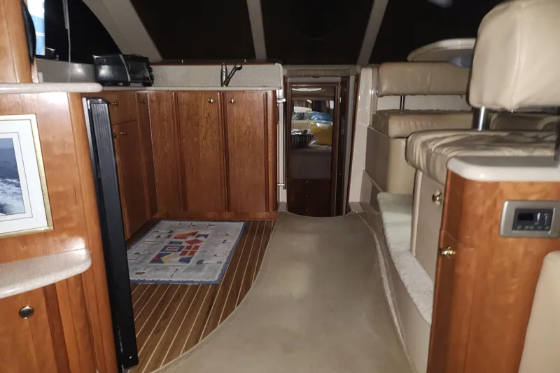 Slide: The Image of Interior of a 2004 Meridian 411 Sedan yacht with wood cabinetry and seating area. - 32