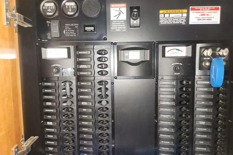 Slide: The Image of Electrical control panel of a 2004 Meridian 411 Sedan yacht with various switches and gauges. - 35
