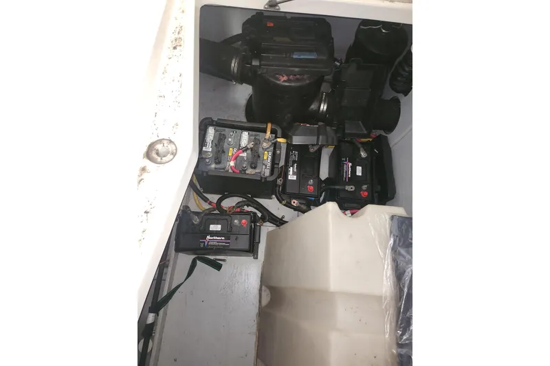 Slide: The Image of Engine compartment of a 2004 Meridian 411 Sedan with visible batteries and components. - 36