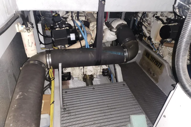 Slide: The Image of Engine room of a 2004 Meridian 411 Sedan, showcasing mechanical components and piping. - 38