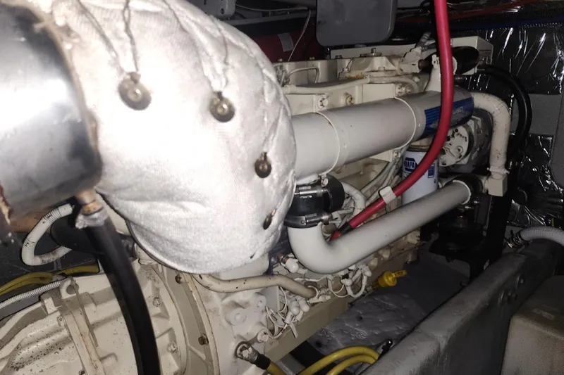 Slide: The Image of Engine compartment of a 2004 Meridian 411 Sedan with visible pipes and wiring. - 45