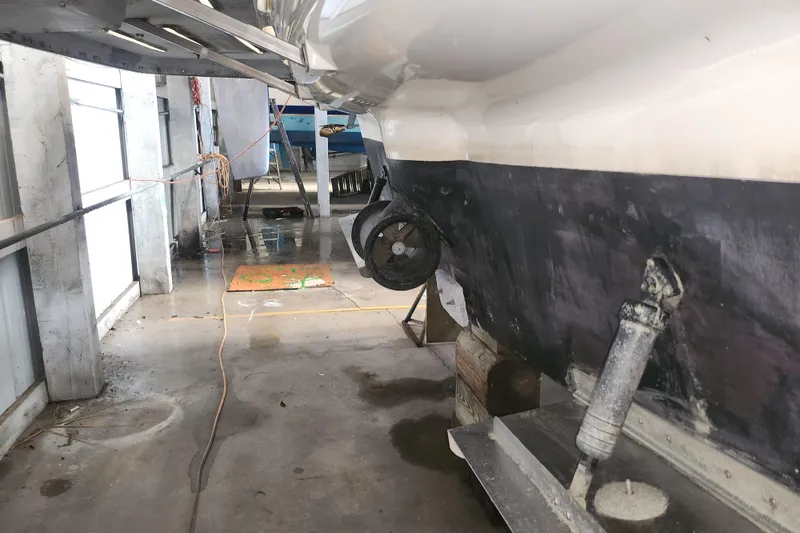 Slide: The Image of 2004 Meridian 411 Sedan in dry dock, showing hull and propeller maintenance. - 49