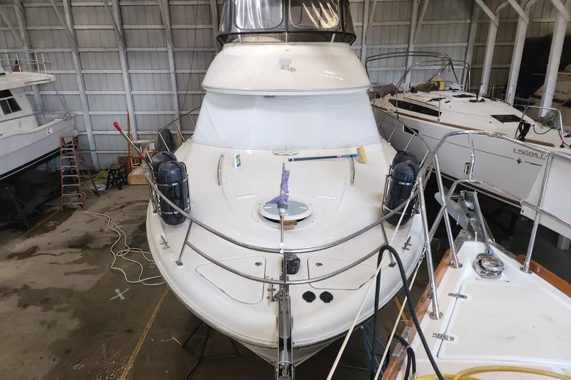 Slide: The Image of 2004 Meridian 411 Sedan yacht in storage, surrounded by other boats in a marina. - 5