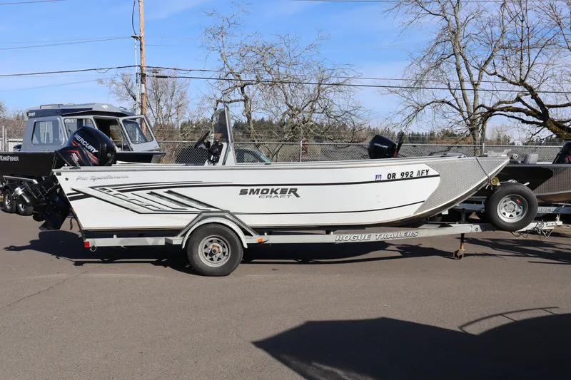 The Image of 2018 Smoker Craft Pro V Sportsman 2072 CC boat on trailer, parked outdoors. - 1