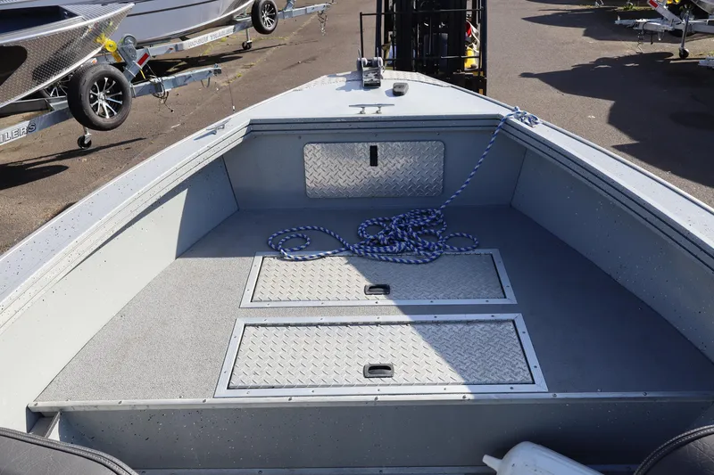Slide: The Image of 2018 Smoker Craft Pro V Sportsman 2072 CC boat interior with storage compartments and rope. - 9
