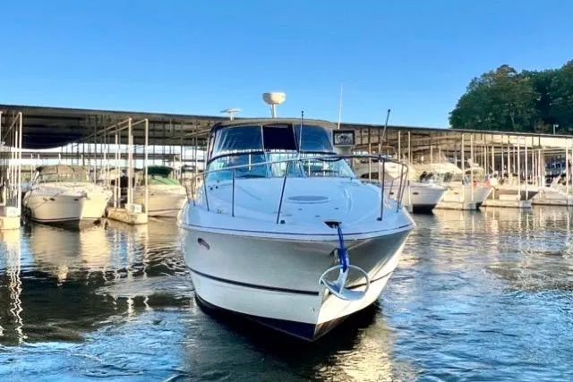 Slide: The Image of 2003 Cruisers Yachts 3772 Express docked in a marina under clear blue skies. - 2