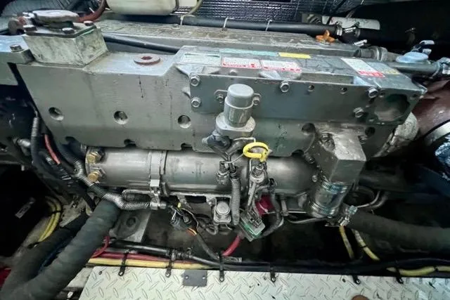 Slide: The Image of Engine compartment of a 2003 Cruisers Yachts 3772 Express, showcasing mechanical components. - 28