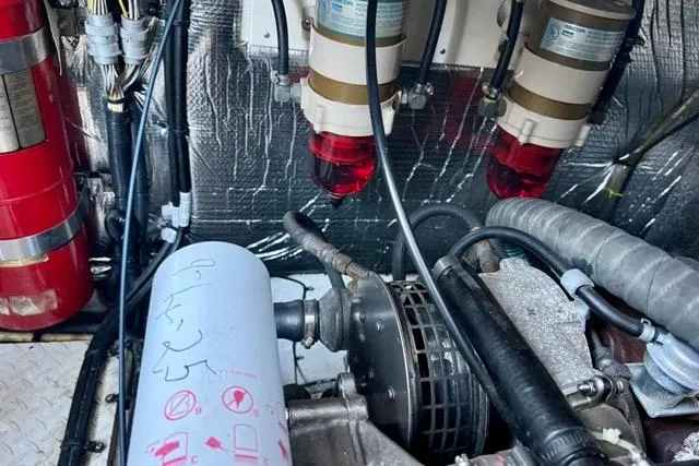 Slide: The Image of Engine room of 2003 Cruisers Yachts 3772 Express, featuring filters and fire extinguisher. - 30