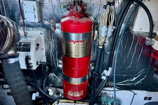 Slide: The Image of Engine room of 2003 Cruisers Yachts 3772 Express with mounted fire extinguisher. - 32