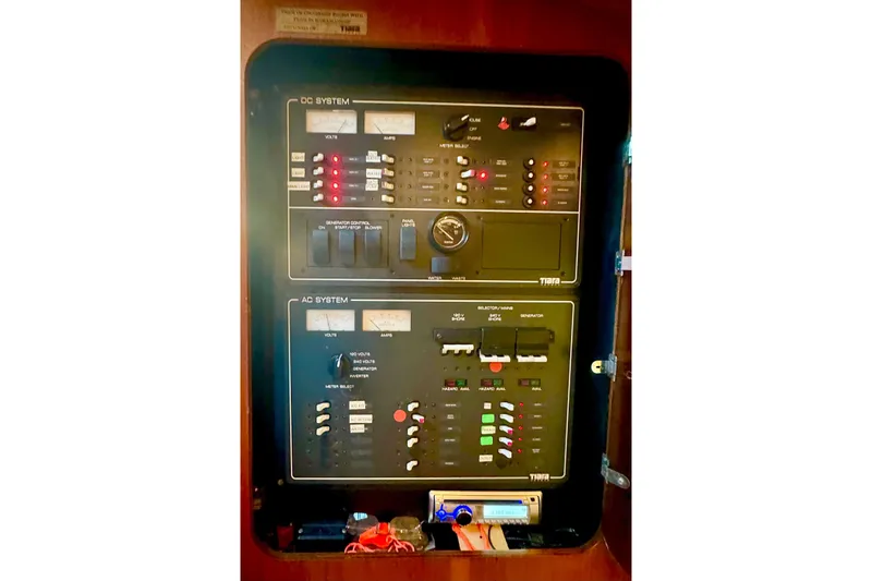 Slide: The Image of Electrical control panel on a 2000 Tiara 37 Open boat, featuring DC and AC systems. - 102