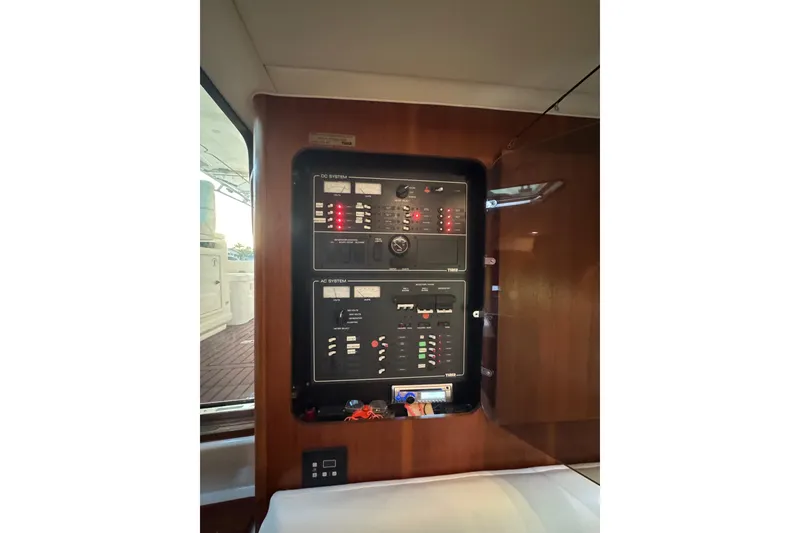 Slide: The Image of Electrical panel inside 2000 Tiara 37 Open yacht, featuring AC and DC systems. - 103