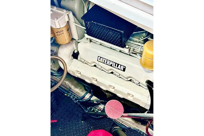 Slide: The Image of Engine compartment of a 2000 Tiara 37 Open with Caterpillar components. - 110