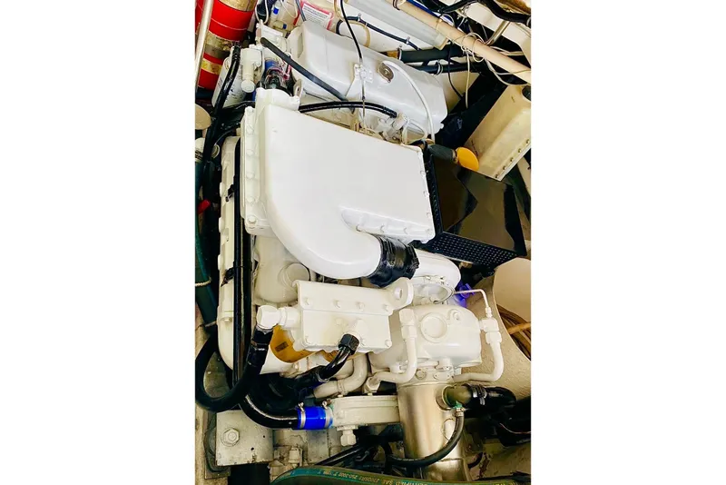 Slide: The Image of Engine compartment of a 2000 Tiara 37 Open boat, showcasing mechanical components. - 111