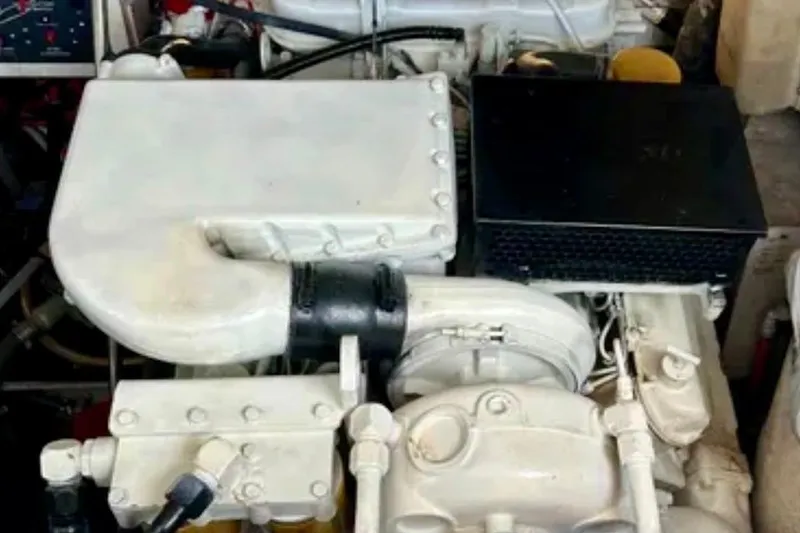 Slide: The Image of Engine compartment of a 2000 Tiara 37 Open boat, showcasing mechanical components. - 113