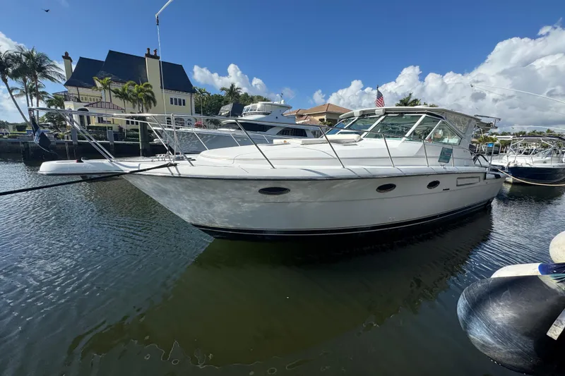 Slide: The Image of 2000 Tiara Yachts 3700 Open docked in a scenic marina setting. - 116