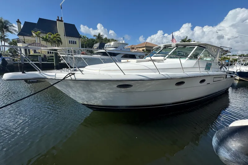 Slide: The Image of 2000 Tiara Yachts 3700 Open docked in a sunny marina setting. - 117