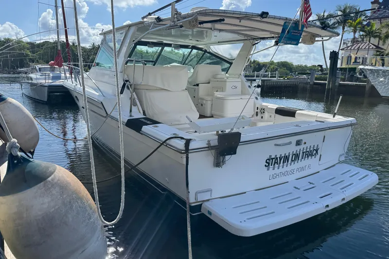 Slide: The Image of 2000 Tiara Yachts 3700 Open docked, featuring spacious deck and sleek design. - 118