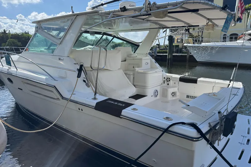 Slide: The Image of 2000 Tiara Yachts 3700 Open docked, showcasing sleek design and spacious deck. - 119