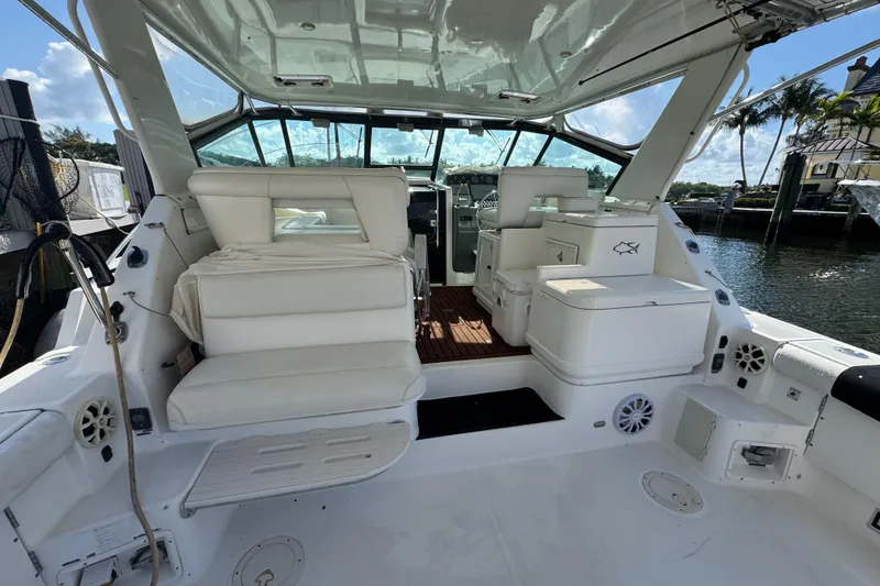 Slide: The Image of Interior view of a 2000 Tiara Yachts 3700 Open, featuring white seating and storage. - 120