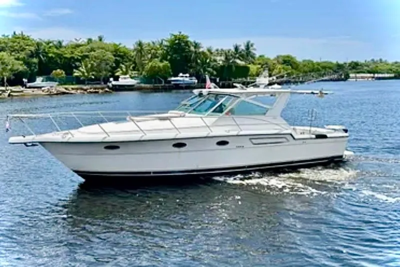 Slide: The Image of 2000 Tiara 37 Open yacht cruising on a sunny day in a scenic waterway. - 2