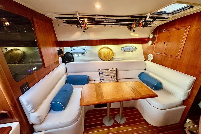 Slide: The Image of Cozy interior of 2000 Tiara 37 Open yacht with wooden table and white seating. - 22