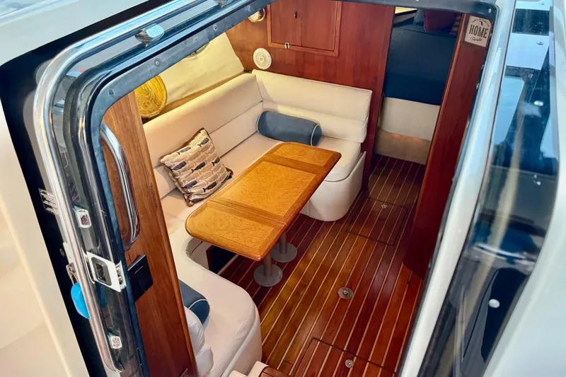 Slide: The Image of Interior of 2000 Tiara 37 Open yacht with wooden flooring and cozy seating area. - 26