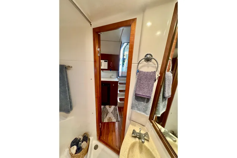 Slide: The Image of Bathroom interior of 2000 Tiara 37 Open yacht, featuring sink and mirror. - 48