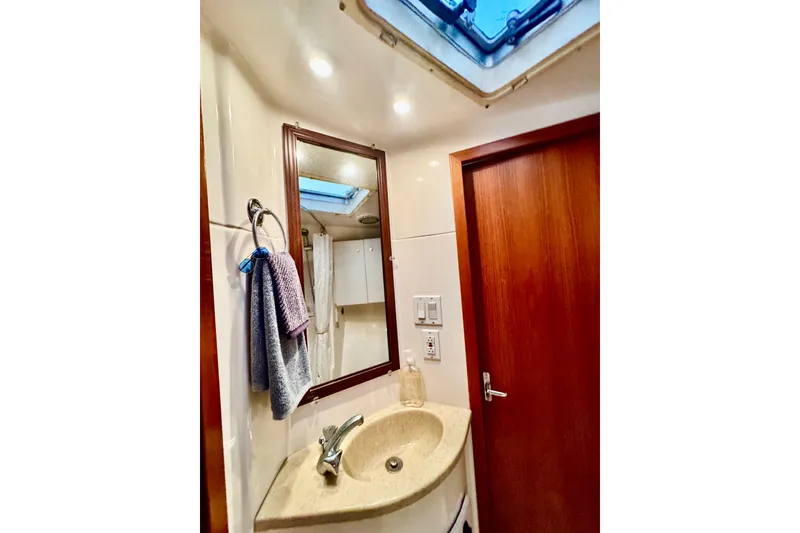 Slide: The Image of Bathroom interior of 2000 Tiara 37 Open yacht, featuring sink, mirror, and skylight. - 50