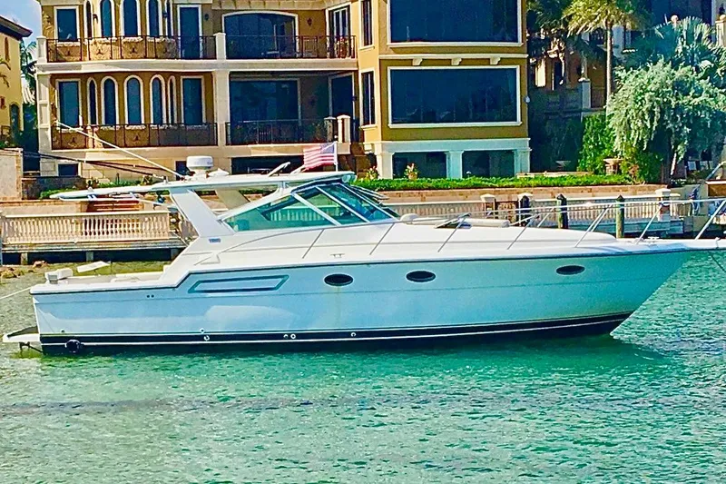 Slide: The Image of 2000 Tiara 37 Open yacht docked near luxury waterfront home. - 61