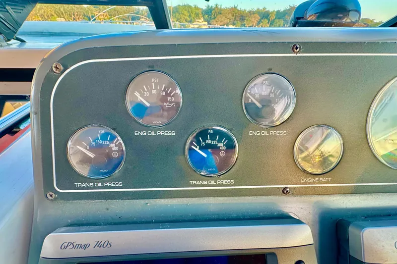 Slide: The Image of Dashboard gauges of a 2000 Tiara 37 Open boat, showing oil pressure and battery levels. - 70