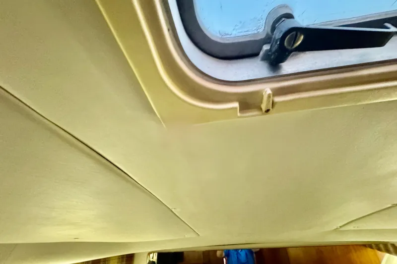 Slide: The Image of Interior ceiling view of a 2000 Tiara 37 Open boat with a hatch window. - 77