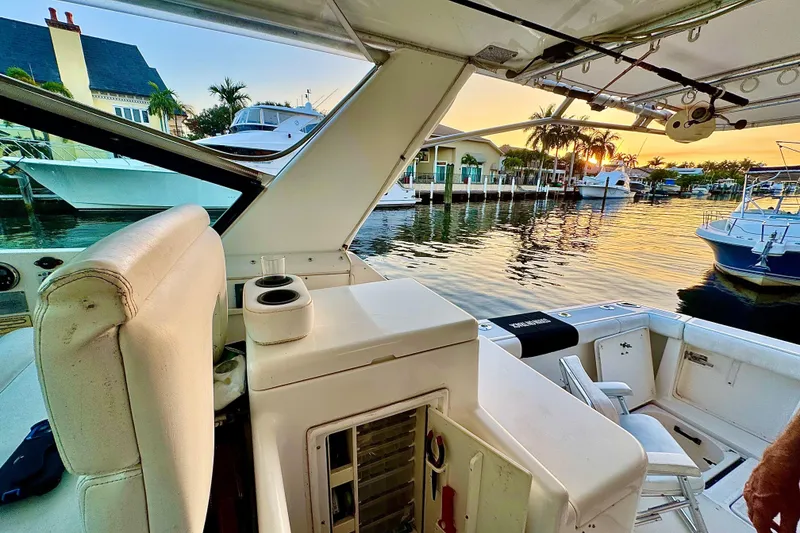 Slide: The Image of 2000 Tiara 37 Open yacht interior with marina view at sunset. - 8