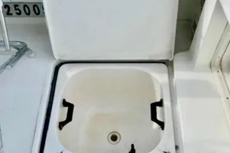 Slide: The Image of Open storage compartment on a 2000 Tiara 37 Open boat deck. - 91