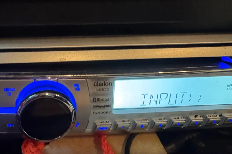 Slide: The Image of Clarion M303 stereo system in a 2000 Tiara 37 Open boat, displaying "INPUT". - 93