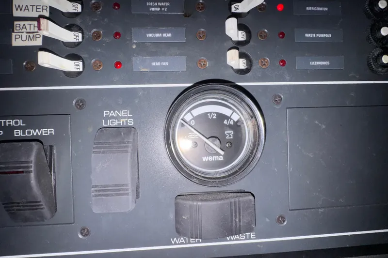 Slide: The Image of Control panel of a 2000 Tiara 37 Open boat with switches and a gauge. - 96