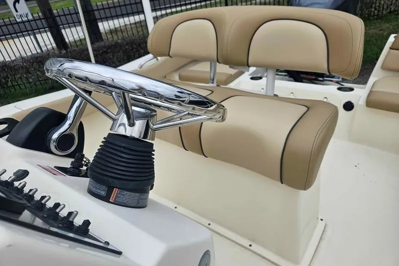 Slide: The Image of 2017 Scout 195 Sportfish boat interior with steering wheel and beige seating. - 5