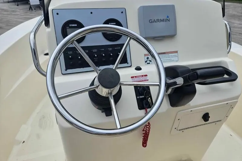 Slide: The Image of 2017 Scout 195 Sportfish boat helm with Garmin navigation and Yamaha controls. - 6