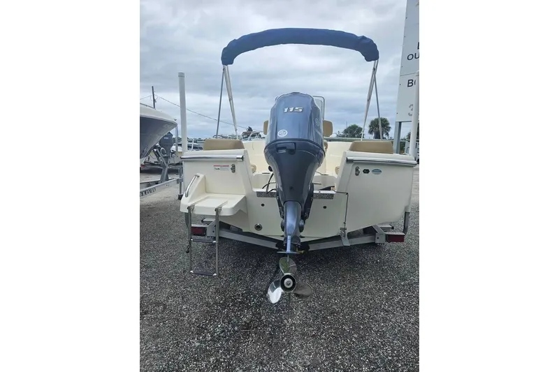 Slide: The Image of 2017 Scout 195 Sportfish boat with outboard motor and blue canopy. - 7