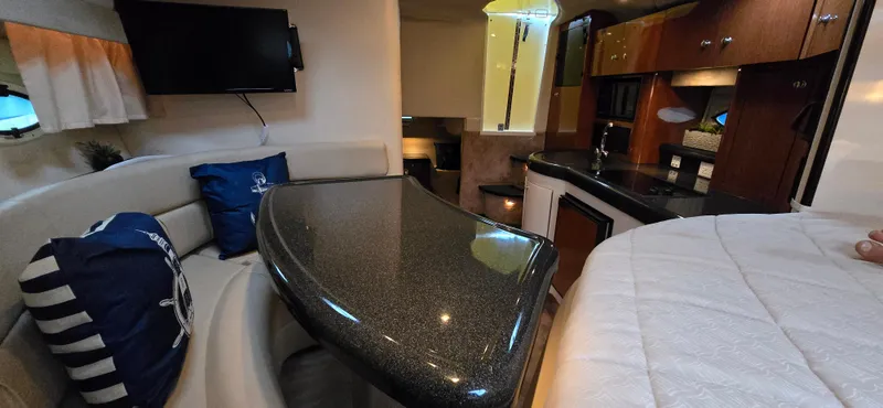 Slide: The Image of Interior of 2002 Monterey 322 Cruiser with modern kitchen and cozy seating area. - 2