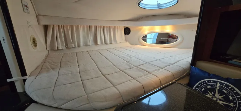 Slide: The Image of Interior cabin of 2002 Monterey 322 Cruiser with cozy bed and porthole window. - 6