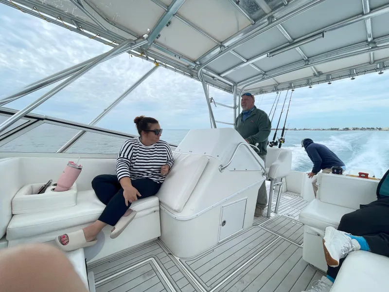 Slide: The Image of People relaxing on a 2001 Contender 35 Side Console boat, cruising on open water. - 6