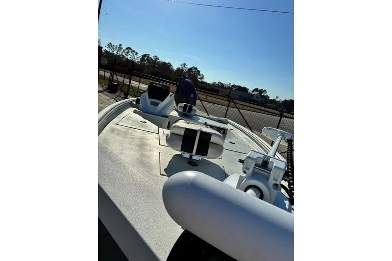 Slide: The Image of 2025 Excel 183 Bolt boat with sleek design, parked outdoors under clear sky. - 7