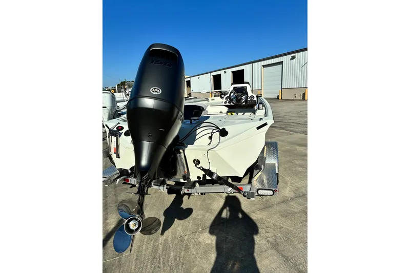 Slide: The Image of 2025 Excel 183 Bolt boat with powerful outboard motor, parked on trailer. - 8