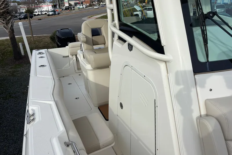 Slide: The Image of 2018 Boston Whaler 250 Outrage boat interior with seating and console view. - 12