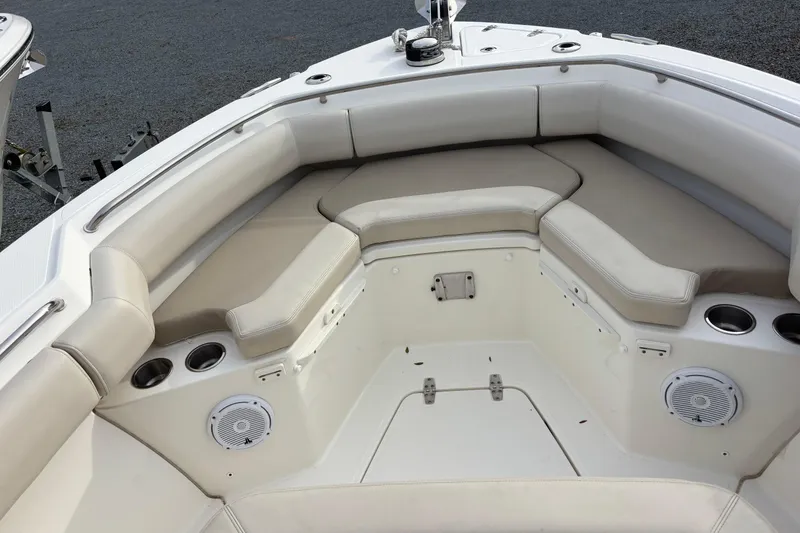 Slide: The Image of 2018 Boston Whaler 250 Outrage boat interior with cushioned seating and cup holders. - 13
