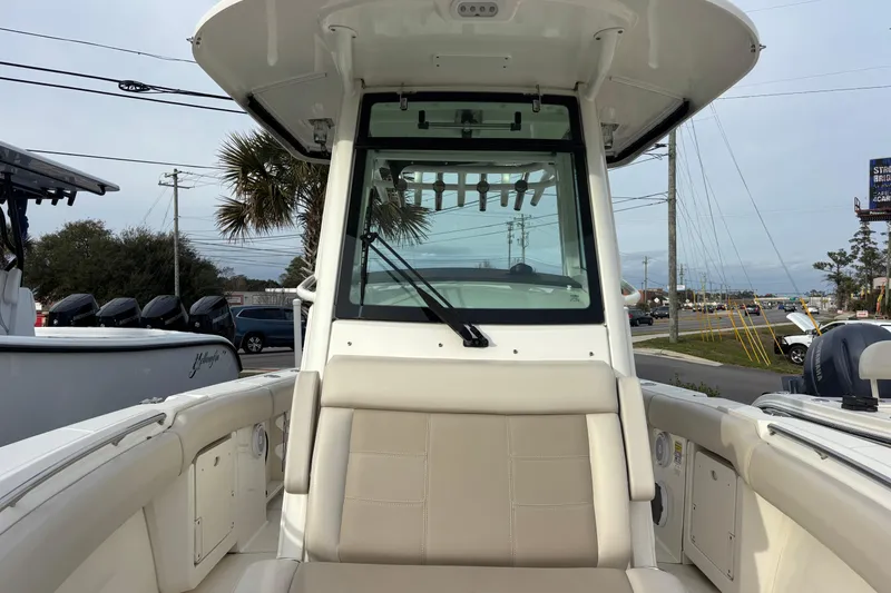 Slide: The Image of 2018 Boston Whaler 250 Outrage boat interior with seating and windshield view. - 14